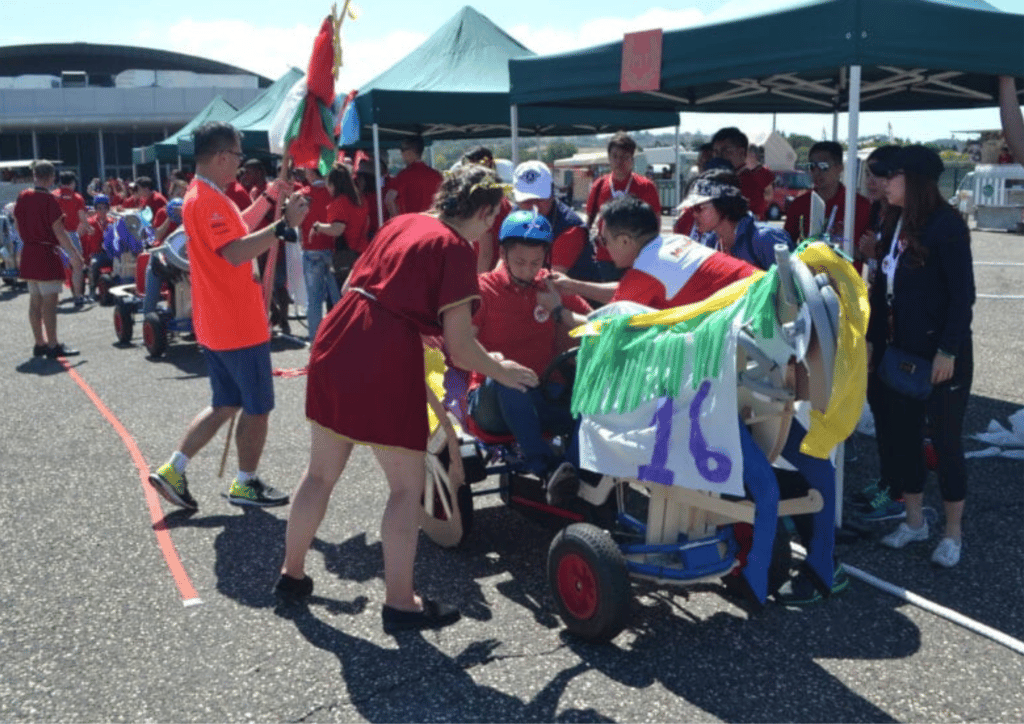 man on chariot team building